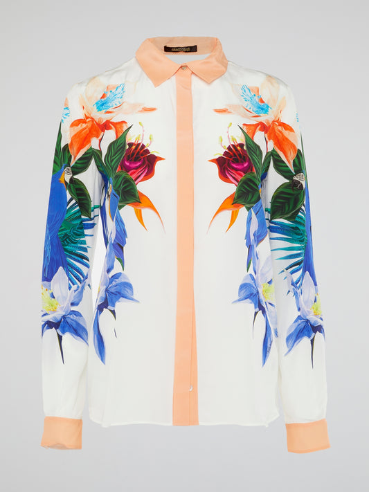 Embrace your inner wildflower with this stunning Flora Print Blouse by Roberto Cavalli. Let the vibrant colors and intricate floral pattern transport you to a lush garden of style and sophistication. Elevate your wardrobe and turn heads wherever you go in this uniquely beautiful piece.