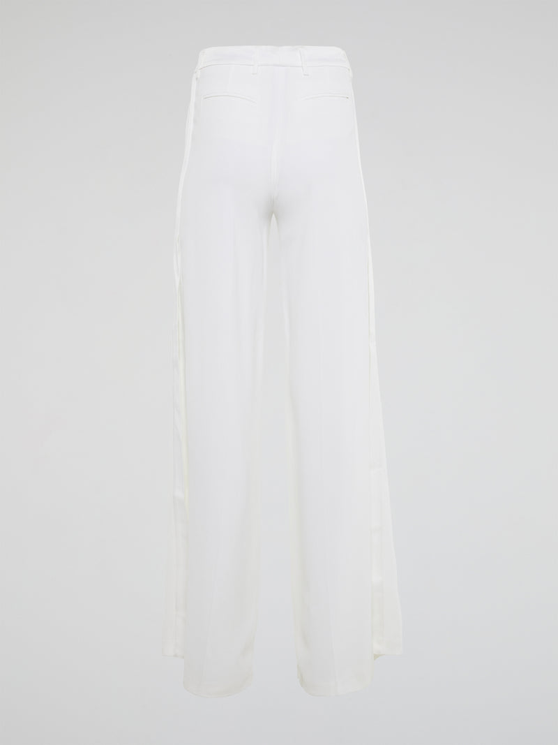 Elevate your style with these stunning white palazzo pants from Roberto Cavalli, designed to make you stand out from the crowd. The luxurious fabric drapes elegantly as you move, creating a sophisticated silhouette that is both comfortable and chic. Perfect for a day at the beach or a night on the town, these palazzo pants are a must-have addition to your wardrobe.