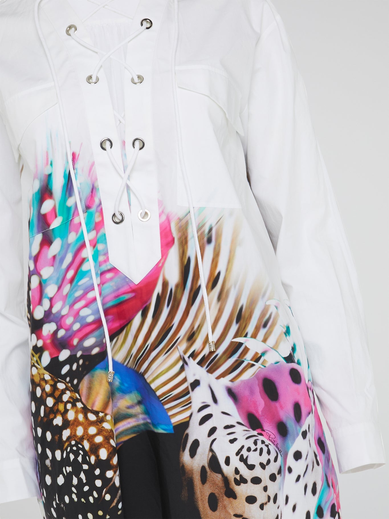 Elevate your wardrobe with the Abstract Print Lace Up Blouse from Roberto Cavalli - a bold and unique piece that exudes confidence and style. Featuring a stunning abstract print and eye-catching lace-up detailing, this blouse is sure to turn heads wherever you go. Make a statement and stand out from the crowd with this must-have addition to your closet.