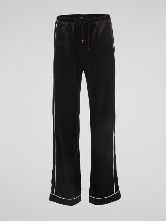Feel bold and sophisticated in these Black Contrast Lining Flared Pants by Roberto Cavalli. The sleek silhouette and dramatic flared legs effortlessly elevate any outfit, making you stand out in a crowd. Embrace your fashion-forward style and turn heads wherever you go with these statement-making pants.