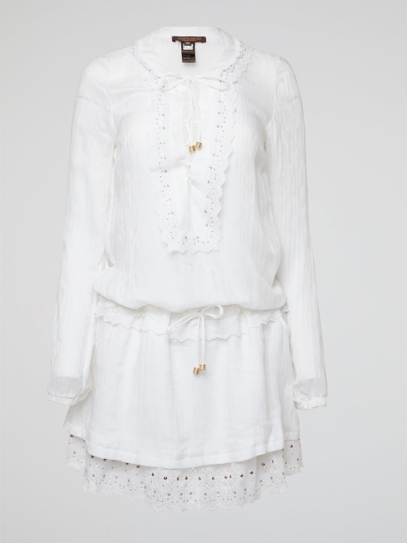 Indulge in the intricate charm of this ethereal white lace up boho dress by Roberto Cavalli, designed to make you feel like a goddess gliding through a field of wildflowers. The delicate lace detailing and flattering silhouette will have you twirling with joy at every summer soiree and beachside sunset. Embrace your inner bohemian spirit and set the trend with this timeless piece that exudes effortless elegance and feminine allure.