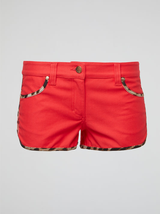 Unleash your wild side with our red leopard trim shorts by Roberto Cavalli, guaranteed to turn heads everywhere you go. The luxurious material and bold print make these shorts the perfect statement piece for any fashion-forward individual. Embrace your inner fashionista and show off your unique and fearless style with these must-have shorts.