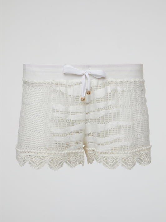Elevate your summer wardrobe with these stunning white knitted shorts by Roberto Cavalli, perfect for lounging by the pool or a chic brunch with friends. Crafted with impeccable attention to detail, these shorts effortlessly blend comfort and style for a truly luxurious feel. Embrace your inner fashionista and make a statement with these must-have shorts that are sure to turn heads wherever you go.