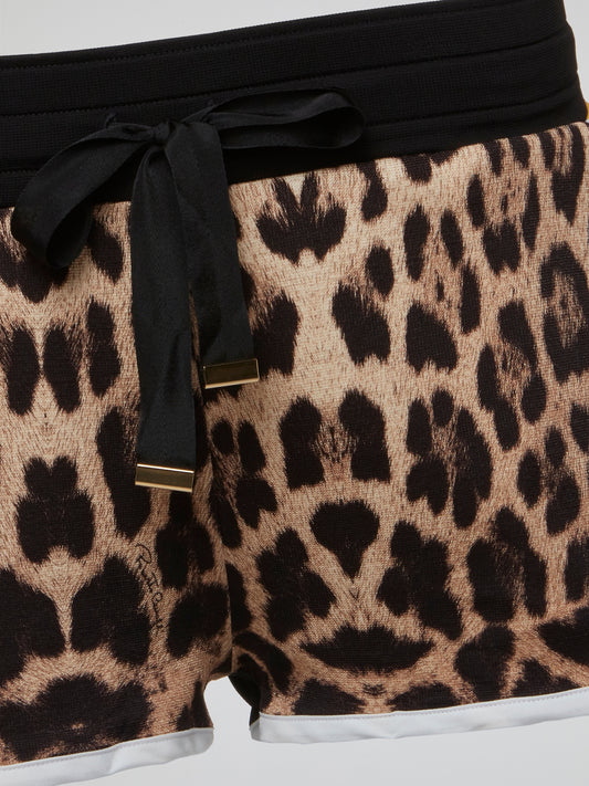 Unleash your wild side with these leopard print drawstring shorts by Roberto Cavalli. Perfect for adding a touch of high-end luxury to your casual summer wardrobe, these shorts are a statement piece that will turn heads wherever you go. Embrace your inner fashionista and stand out from the crowd with these fiercely fabulous shorts.