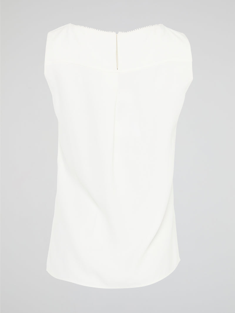 Introducing a timeless masterpiece for fashion-forward mavens - the White Sleeveless Top by Akris Punto. This ethereal beauty effortlessly combines sophistication and elegance with its minimalist design and impeccable tailoring. Crafted from luxurious fabrics, it's the perfect versatile piece to elevate your style, ensuring you're the epitome of chic from desk to dinner.