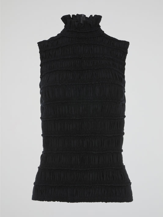 The Black High Neck Tiered Top by Akris Punto perfectly combines elegance and modernity in one stunning piece. With its high neckline and tiered design, this top effortlessly adds depth and movement to any ensemble. Whether paired with trousers for a chic office look or dressed up with a statement skirt for a special evening event, this top is a must-have addition to your wardrobe.