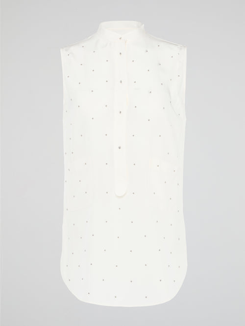 Unleash your fierce, fashion-forward side with the White Studded Sleeveless Shirt by Akris Punto. Crafted with meticulous attention to detail, this statement piece is adorned with intricately placed studs that exude edgy sophistication. Perfectly blending poise and rebellious spirit, this sleeveless shirt is a captivating must-have for those seeking to redefine their style game.