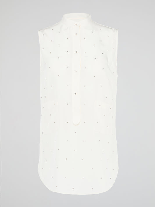Unleash your fierce, fashion-forward side with the White Studded Sleeveless Shirt by Akris Punto. Crafted with meticulous attention to detail, this statement piece is adorned with intricately placed studs that exude edgy sophistication. Perfectly blending poise and rebellious spirit, this sleeveless shirt is a captivating must-have for those seeking to redefine their style game.