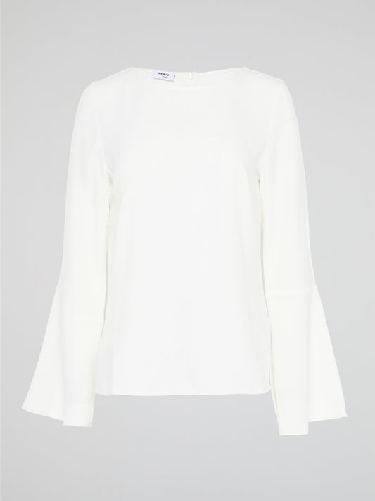 Elevate your everyday look with the White Flared Sleeve Top by Akris Punto. This contemporary and chic piece features unique flared sleeves that add a playful twist to your outfit. Made with high-quality materials, this top guarantees comfort and style, making it a must-have addition to your wardrobe.