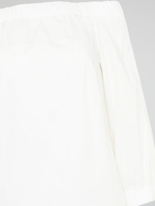Elevate your summer wardrobe with our White Off-Shoulder Top by Akris Punto. Embrace a touch of effortless elegance as the delicate fabric gracefully drapes off your shoulders, exuding femininity and style. With its versatile design, this top is perfect for both casual outings and special occasions, ensuring you always feel chic and glamorous wherever you go.