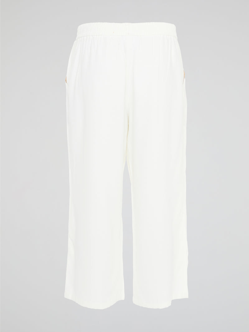 Introducing the ultimate embodiment of chic and comfort - the White Wide Leg Cropped Pants by Akris Punto. Crafted with meticulous attention to detail, these pants effortlessly blend sophistication and versatility, making them the perfect addition to any fashionista's wardrobe. Whether you're strolling on sandy beaches or attending a high-profile event, these pants will elevate your style game with their impeccable tailoring and striking silhouette.