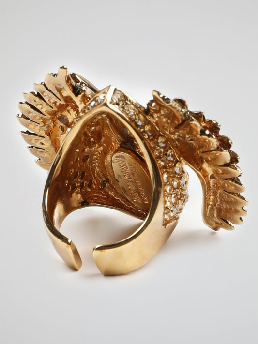 Introducing the Gold Crystal Bird Ring by Roberto Cavalli - an exquisite masterpiece that captures the essence of elegance and grace. Crafted with meticulous attention to detail, this stunning ring features a delicate bird motif adorned with shimmering crystals in a captivating gold setting. Let your style take flight with this exquisite accessory that combines nature's beauty with Roberto Cavalli's signature opulence.