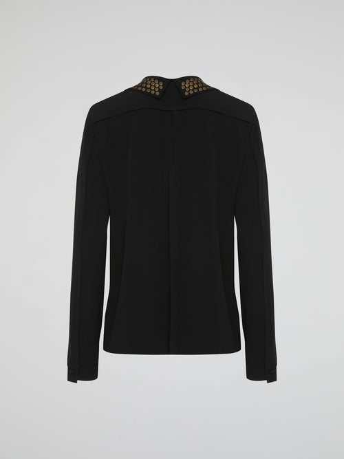 Step into the world of fierce elegance with the Black Studded Collar Blouse by Roberto Cavalli. This extraordinary piece effortlessly combines edgy appeal with timeless sophistication, making it a versatile addition to any wardrobe. With its luxurious fabric, daring studded collar, and impeccable craftsmanship, this blouse is a bold statement that exudes confidence and pushes boundaries.