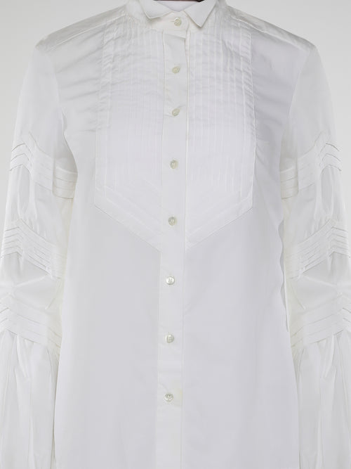 Step into the world of timeless elegance with the White Pleated Bib Shirt from Roberto Cavalli. Crafted with meticulous attention to detail, this masterpiece combines effortless sophistication with a touch of whimsical charm. From its delicate pleated bib to its crisp white fabric, this shirt will make a statement in any setting, exuding refined elegance that is truly captivating.