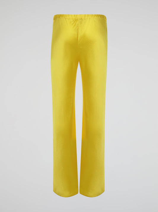 Step up your style game with these vibrant Yellow Drawstring Silk Trousers by Roberto Cavalli. Crafted from luxurious silk, these statement trousers offer a silky soft touch and a flowing silhouette that is both elegant and comfortable. Perfect for any occasion, let these eye-catching pants be the star of your ensemble.