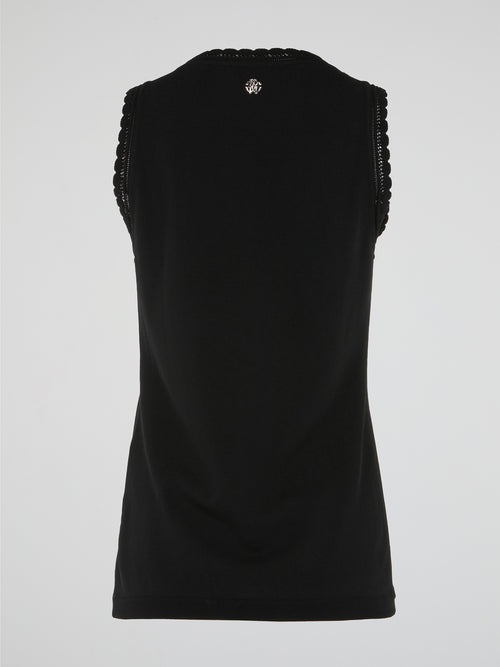 Introducing the exquisite Black Lace Trim Top by Roberto Cavalli, a true embodiment of elegance and sophistication. Crafted with meticulous attention to detail, it features delicate lace detailing that adds a touch of femininity to the classic black design. Whether paired with tailored pants or a flowing skirt, this timeless piece is bound to turn heads and make a lasting impression.