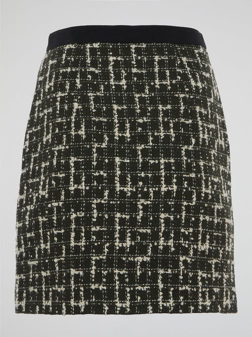 Step into the world of elegance and sophistication with the Tweed Mini Skirt by Emanuel Ungaro. Crafted with the utmost care, this skirt effortlessly fuses timeless style with a contemporary edge. From office meetings to evening soirees, embrace your inner fashionista and make a statement wherever you go with this iconic piece.