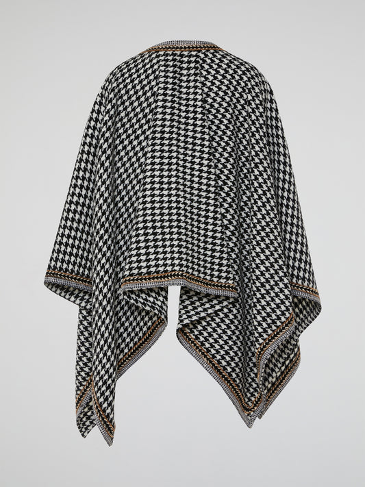 The Houndstooth Embellished Poncho by Ella Luna is the perfect blend of classic and contemporary style. Crafted with meticulous attention to detail, this luxurious poncho features a mesmerizing houndstooth pattern that instantly elevates any outfit. Its elegant embellishments add a touch of glamour, making it a must-have statement piece for every fashion-forward individual.
