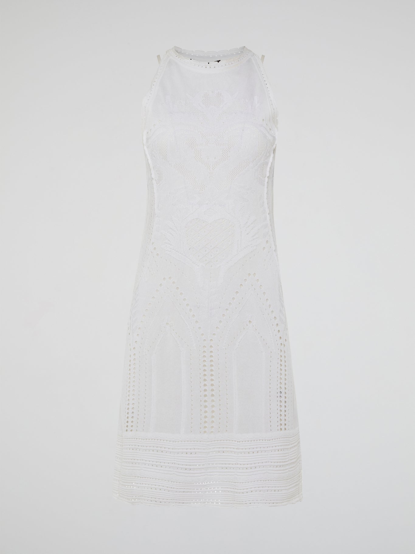 Dance into shimmering moonlit nights in the ethereal beauty of the White Knitted Sleeveless Dress by Roberto Cavalli. Crafted with meticulous artistry, this exquisite dress features delicate knitted patterns that seamlessly cascade down your curves, creating an enchanting silhouette. With its timeless elegance and romantic charm, this dress is a masterpiece that exudes pure grace and allure.