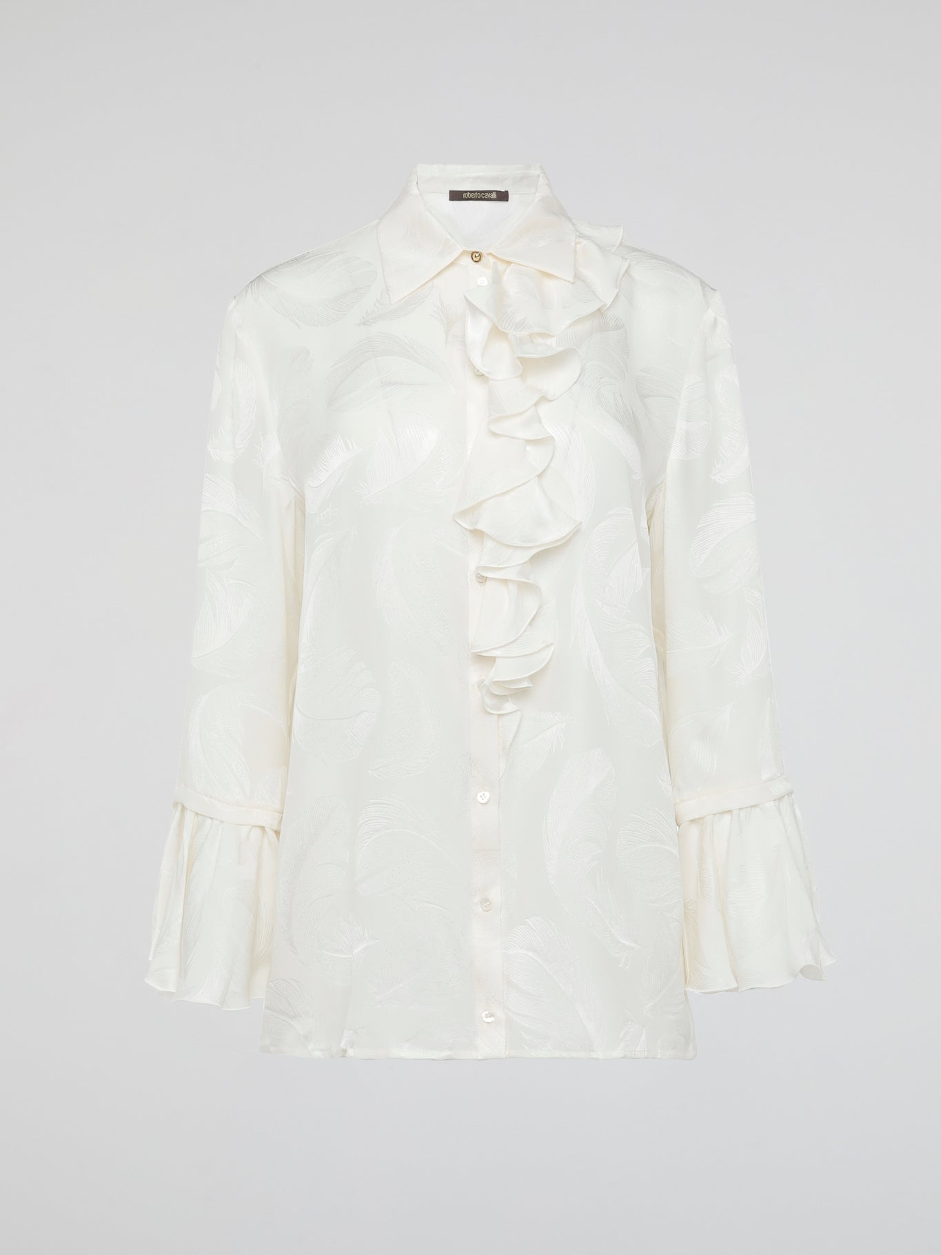 Embrace the essence of high-end fashion with the Ruffle Detailed Shirt by Roberto Cavalli. This stunning piece perfectly combines elegance and playfulness with its intricate ruffles that gracefully dance along the collar and cuffs. Crafted from luxurious materials, this shirt is a true statement piece that effortlessly elevates any outfit.