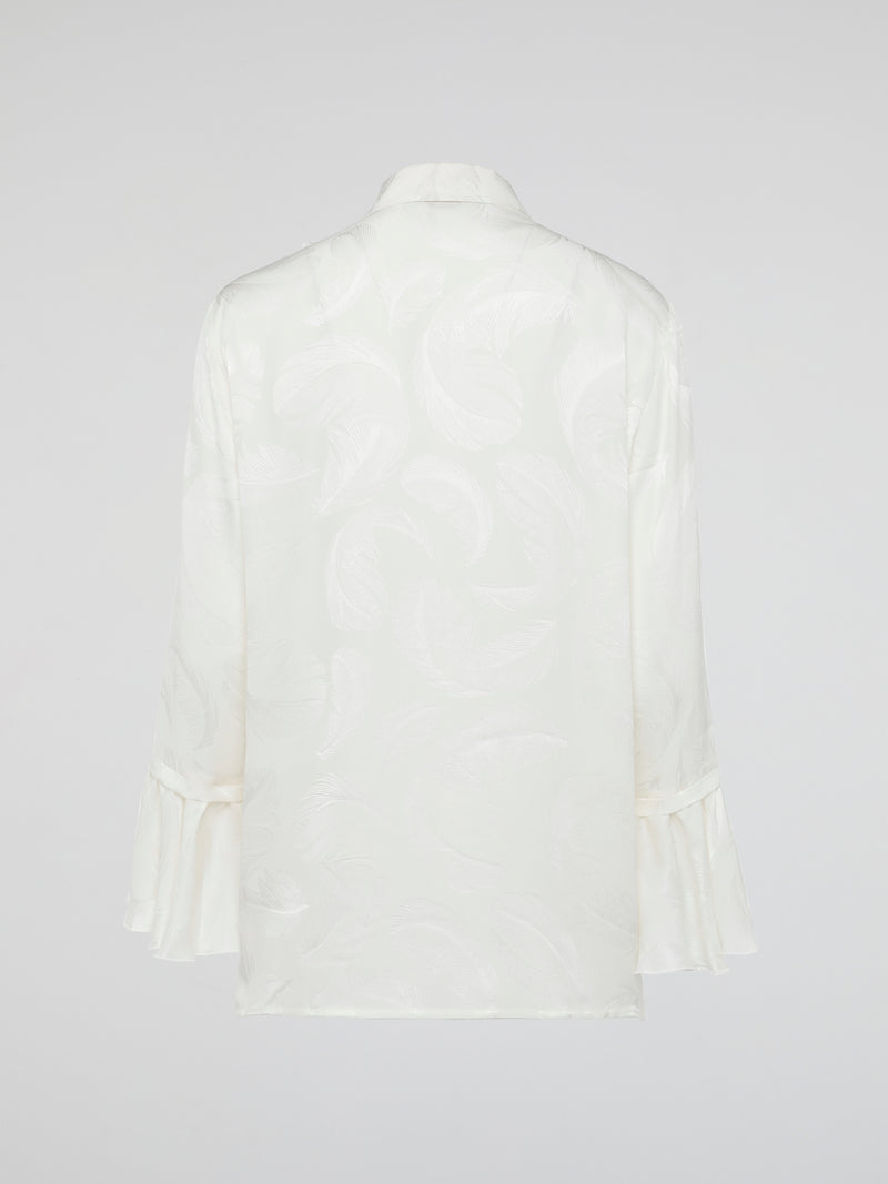 Embrace the essence of high-end fashion with the Ruffle Detailed Shirt by Roberto Cavalli. This stunning piece perfectly combines elegance and playfulness with its intricate ruffles that gracefully dance along the collar and cuffs. Crafted from luxurious materials, this shirt is a true statement piece that effortlessly elevates any outfit.