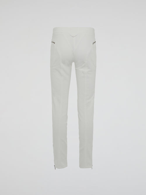 Introducing the epitome of style and sophistication - the White Zipper Detailed Trousers by Roberto Cavalli. These exquisite trousers blend modern minimalism with edgy details, boasting a sleek white hue that exudes elegance. The alluring zipper accents strategically placed throughout add a touch of rebellious charm, making these trousers a true fashion statement.