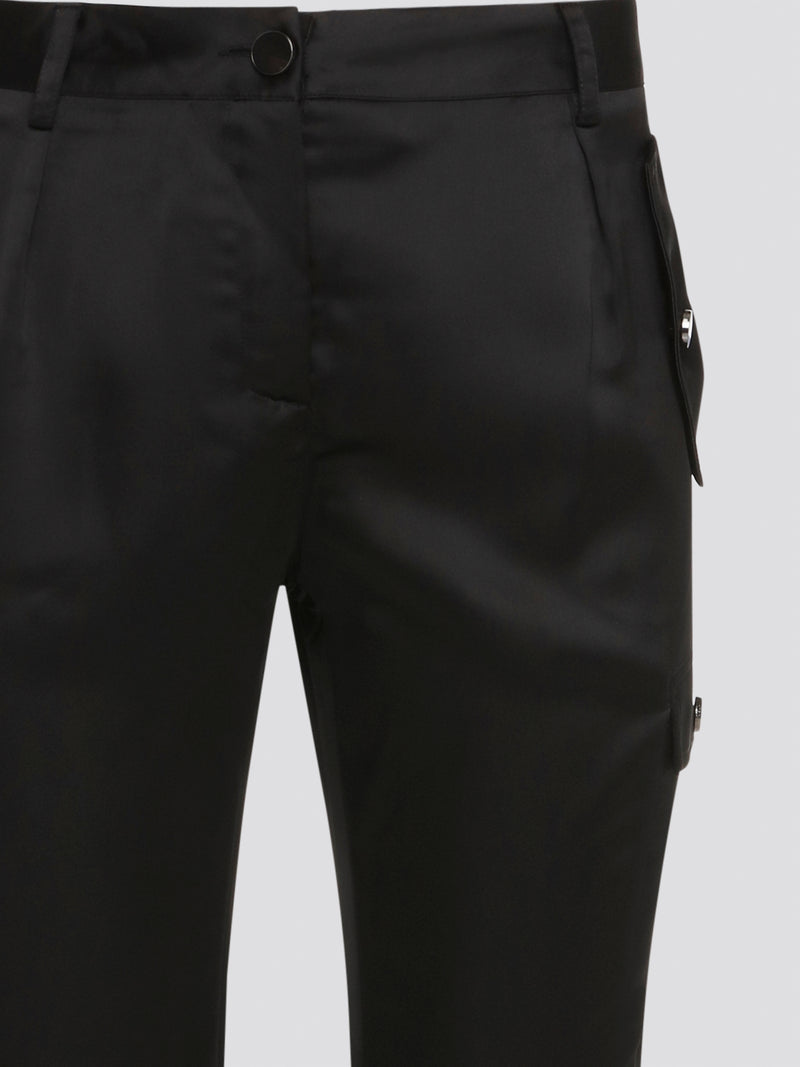 Elevate your everyday look with these sleek and stylish Black Cargo Pants from Roberto Cavalli. Made with premium quality materials, these pants are not only comfortable but also durable for long-lasting wear. With their trendy cargo pockets and tapered fit, they are the perfect statement piece for any fashion-forward individual.