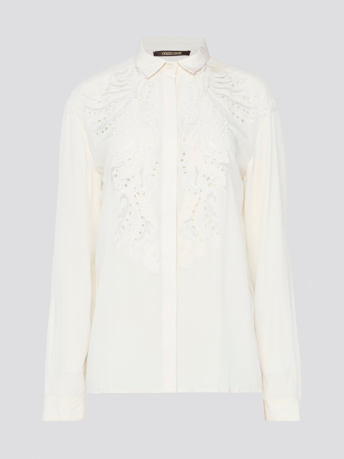Feel like a bohemian queen in this exquisite white embroidered long sleeve blouse from Roberto Cavalli. The intricate detailing and luxurious fabric create a stunning and timeless piece that is perfect for any occasion. Elevate your wardrobe and make a statement with this elegant and unique blouse.