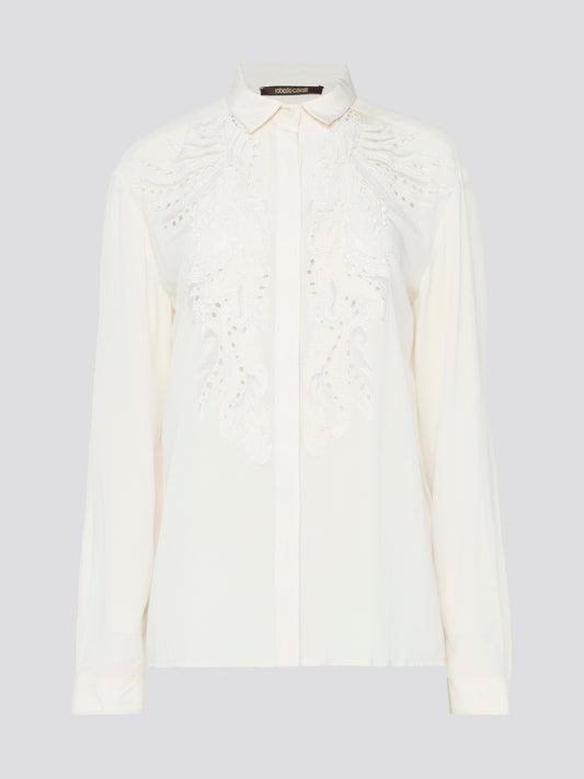 Feel like a bohemian queen in this exquisite white embroidered long sleeve blouse from Roberto Cavalli. The intricate detailing and luxurious fabric create a stunning and timeless piece that is perfect for any occasion. Elevate your wardrobe and make a statement with this elegant and unique blouse.
