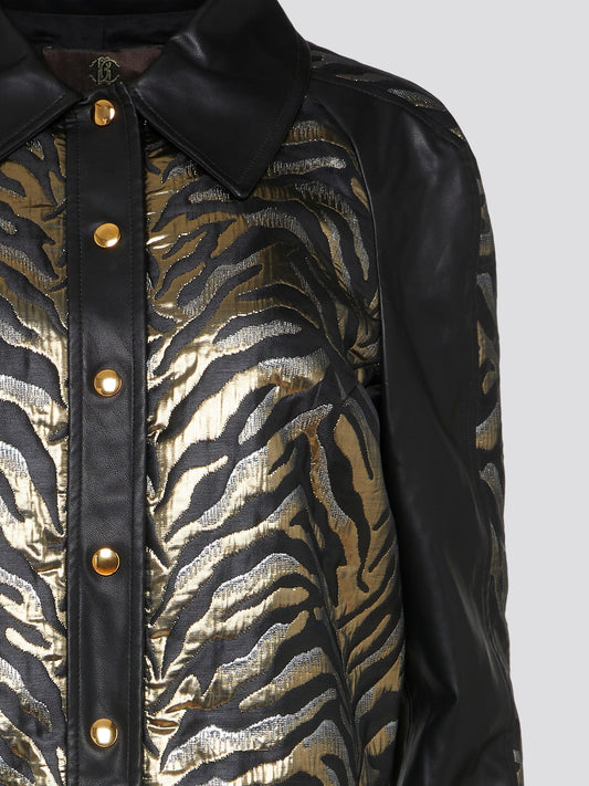Add a fierce touch to your wardrobe with this stunning tiger print leather jacket by Roberto Cavalli. Crafted from premium leather and featuring a bold tiger print design, this jacket is sure to make a statement wherever you go. Whether you're dressing up a casual outfit or adding an edge to a night out look, this jacket is the perfect way to showcase your wild side.