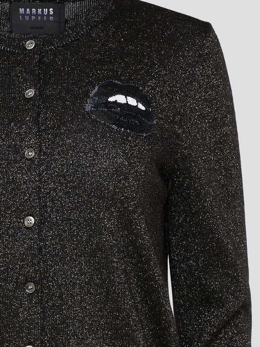 Infuse a touch of edge and elegance with the Black Glittered Button Down Cardigan by Markus Lupfer. This eye-catching piece features shimmering black glitter that adds a touch of sparkle to any outfit. Perfect for layering over a classic blouse or styling on its own for a bold statement look, this cardigan is a must-have for the fashion-forward individual.