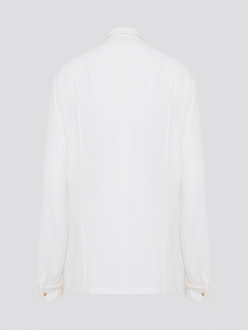 Elevate your wardrobe with this stunning Roberto Cavalli white detailed long sleeve shirt. Crafted with exquisite attention to detail, this shirt features intricate embroidery and embellishments that exude luxury and elegance. Perfect for adding a touch of sophistication to any ensemble, this statement piece is sure to turn heads wherever you go.
