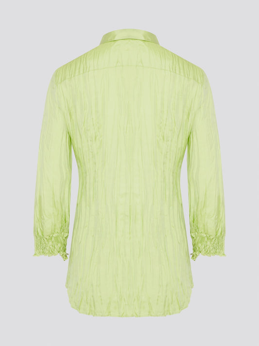 Step into the wild side with this striking green crinkled shirt from Roberto Cavalli. The vibrant hue and unique texture of the fabric will ensure you stand out from the crowd wherever you go. Embrace your fearless fashion sense and unleash your inner style icon with this must-have statement piece.