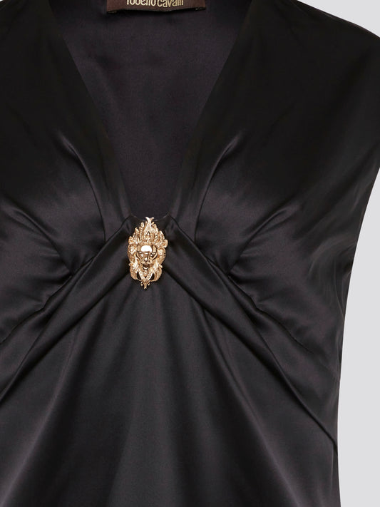 Make a bold statement with the Black Embellished Top by Roberto Cavalli, guaranteed to turn heads wherever you go. With intricate detailing and luxurious fabrics, this top is the epitome of high-end fashion. Elevate your wardrobe and stand out from the crowd with this stunning piece from one of the world's most renowned designers.