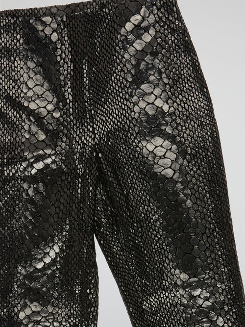 Unleash your wild side with our Black Reptilian Leather PantsIceberg, designed to make a bold statement. Crafted from high-quality faux leather with a sleek reptile texture, these pants are perfect for standing out in a crowd. Embrace your inner rockstar and take your style to the next level with these edgy and stylish pants.