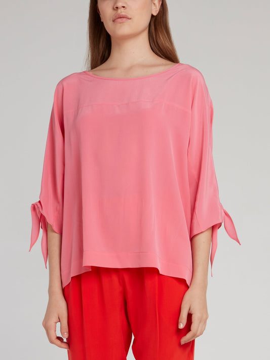 Розовая блузка с завязками на рукавах