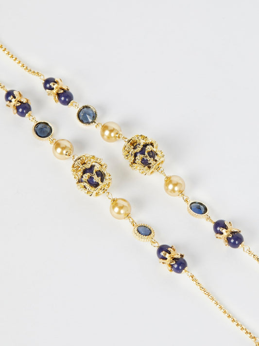 Золотое ожерелье с темно-синими бусинами